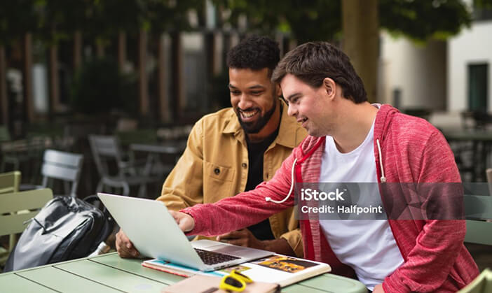 Photo of two men on a laptop