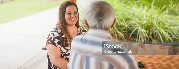 A woman smiling at an older man